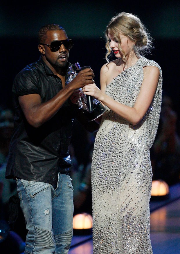 After 11 years, Kanye West has finally explained as to why he interrupted Taylor Swift’s VMA acceptance speech in 2009. And he thinks God had something to do with it because obviously he got the signal from Him to interrupt the rising star of that time while she was receiving her much deserved award.  What Happened At VMA 2009? Taylor Swift received the Best Female Video award at MTV VMAs in 2009 instead of Beyoncé who expected to be the winner. When she went to get her award and started giving the speech, West barged onto the stage and interrupted her big moment on live TV. He has now given the reason that he thinks it was God’s doing because it is outrageous as to how she could have beat Bey in winning the Single Ladies video award. What Did Kanye West Say? Kanye revealed that it was God’s plan who seated him in the front row so he could have immediate access to act on impulse when Taylor received the award. He said: “Right now, God is giving me the information. If God ain’t want me to run on stage and say Beyoncé had the best video, he wouldn’t have sat me in the front row. I would’ve been sitting in the back.” We know that wasn’t possible since he was the biggest music star of that time and the telecast products always give the bigwigs the front row. So, clearly, it wasn’t God who decided the seat placement. He further said that he had no idea who Taylor was and why was she accepting the award for, ‘You Belong To Me’. “They wouldn’t have made it the first award. It’s so ridiculous of an idea because, I had never heard of this person [Taylor] before, and ‘Single Ladies’ is, like, one of the greatest videos of all time.” Kanye Was Drunk! The fact that he was seen swigging in a bottle of Hennessy at the Red Carpet might very well have to do with why he acted the way he acted rather than God telling him to take an action. However, West claims that his presence was a ‘set-up’ and he was totally in his senses.  “And I was only drinking Hennessy because I didn’t want to go to the awards show because it was a set-up.” Now we thought he said that it was God who wanted him to sit at the front row to defend Beyoncé’s award. But now he is saying it was a set-up. We will give Kanye another 11 years to figure out what actually happened and who instigated him to do what he did. Was it really God or his internal jealousy acting out? 